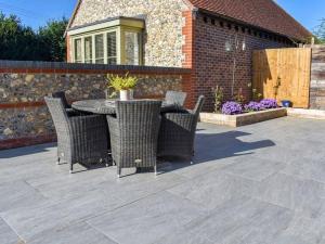 a patio with a table and chairs on a patio at Blundens Holiday Lets - Hatfield in Chichester
