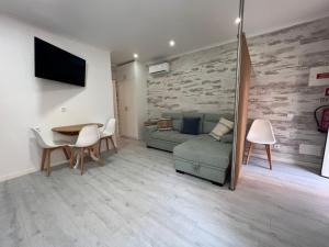 a living room with a couch and a table at Bluebay Sesimbra - Laura in Sesimbra