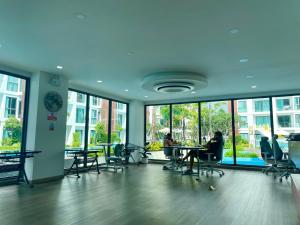 a room with people sitting at tables in a building at Near Central Festival- 5mims Walk- Infinity Pool & Comfort Room@The One Chiang Mai Condo in Chiang Mai +152 photos