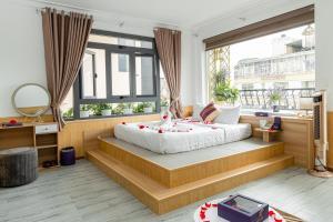 a bedroom with a large bed and a large window at Sweet Lavender Hotel - Near Dalat Night Market in Da Lat