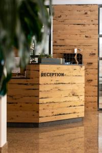 a reception desk in a room with wooden walls at Hotel Rosa in Lido di Jesolo