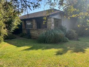 a small stone house in a yard at Cosy and Serene Environment in Boksburg