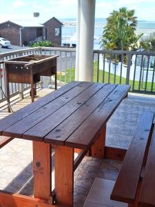 a wooden picnic table on top of a deck at Fairview Accommodation in Gansbaai
