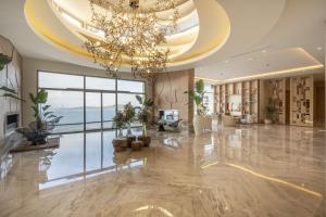 a large lobby with a chandelier and a large room at Del Mare Reserve Hotel & Spa Bodrum in Bodrum City