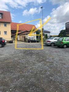 a yellow ribbon in front of a parking lot at 1-ZKD mit EBK, modern und barrierefrei, SELF-CHECK-IN in Ittlingen