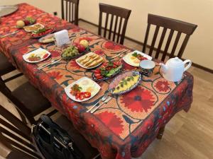 a table with plates of food and a teapot at "S e a s o n S" in Samarkand