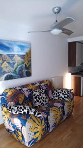 a couch in a living room with a painting on the wall at New, cozy apartment Plaza del Pilar-Fuenclara in Zaragoza