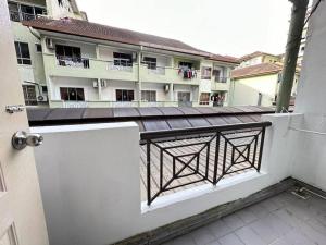 an empty balcony with a building in the background at KK City A2Z Api Api Modern Studio Homestay in Kota Kinabalu