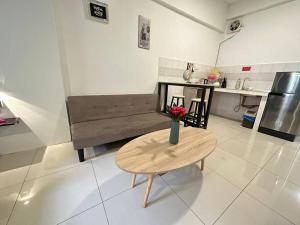 a living room with a table and a couch at KK City A2Z Api Api Modern Studio Homestay in Kota Kinabalu