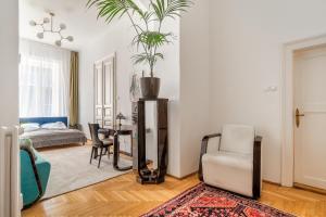 a living room with a table and a chair at Aviator luxury apartment in the city center in Budapest