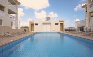 a swimming pool in the middle of a building at Welcome to Thea Court in Paralimni