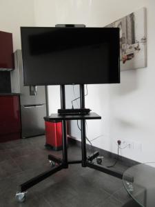 a flat screen tv on a stand in a room at Meublés des 3 îles in Châtelaillon-Plage