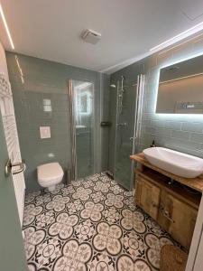 La salle de bains est pourvue d'un lavabo, d'une douche et de toilettes. dans l'établissement In Abrahams Schoß, à Blankenfelde-Mahlow