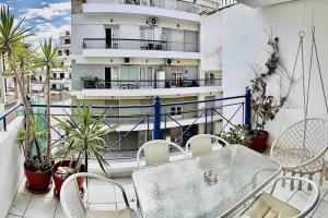 a balcony with a table and chairs and a building at 3 Bedrooms Maisonette in Patra
