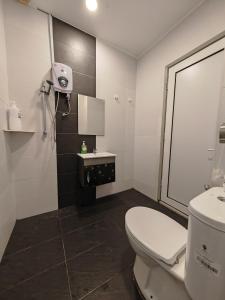 a bathroom with a toilet and a sink at Homestay Melaka Mahkota Melaya Raya in Melaka