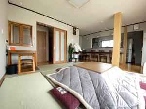 a living room with a bed and a kitchen at LINK HOUSE in Fujiyoshida