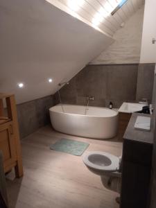 a bathroom with a tub and a toilet and a sink at joseph in Monschau +40 photos