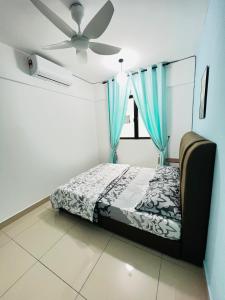 a bedroom with a bed and a ceiling fan at JC HOMESTAY RAWANG in Rawang