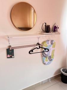 a mirror and a towel rack in a bathroom at JC HOMESTAY RAWANG in Rawang