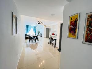 a white hallway with a dining room and a living room at JC HOMESTAY RAWANG in Rawang