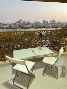 a white table and two chairs on a balcony at Dubai NorthStar Hostels in Dubai