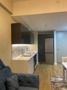 a kitchen with black cabinets and a couch in a room at DIAMOND OF SKOPJE JB in Skopje