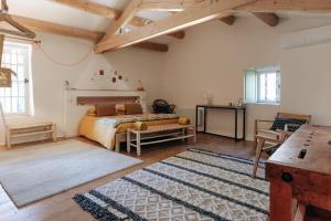 a bedroom with a bed and a table in a room at Maison 1643 in Laudun