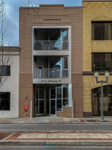 a brick building with a balcony on the side of it at Roanoke Roofdeck Loft. Central Downtown Location. in Roanoke