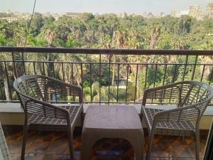 two chairs and a table on a balcony at St.George in Cairo