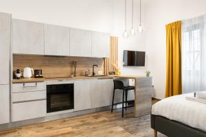 a kitchen with a desk and a bed in a room at Studio in the heart of Cluj in Cluj-Napoca