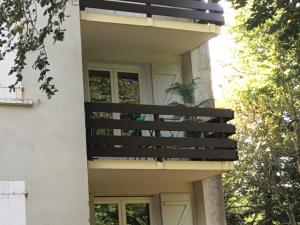 a house with a black balcony on the side of it at Lo Cantalés d’Aubrac in Laguiole +15 photos