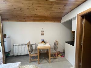 a small dining room with a table and two chairs at Small house Floki in Žabljak