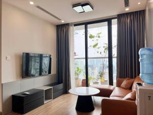 un salon avec un canapé et une télévision dans l'établissement NanaHousing-Vinhomes Skylake-Luxury Apartment near Keangnam, à Hanoï