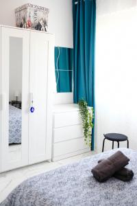 a bedroom with a bed and a blue curtain at Lima Residence in Nicosia