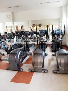 a gym with several treadmills and elliptical machines at Madrid Las Tablas apartments in Madrid