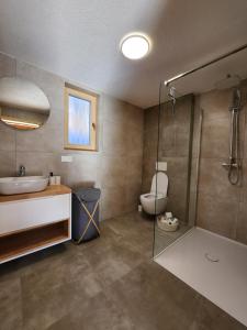 a bathroom with a toilet and a sink and a shower at Chalet Fiona with jacuzzi in Mýto pod Ďumbierom +43 photos