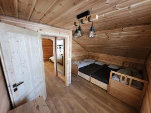 a room with a bed in a wooden cabin at Chalet Fiona with jacuzzi in Mýto pod Ďumbierom