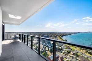 an apartment balcony with a view of the ocean at Modern, Spacious 2BR Penthouse with Bay Views in Geelong