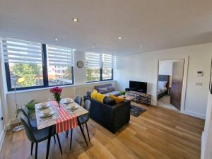 a living room with a couch and a table at Free Parking: Old Trafford Apartment in Manchester