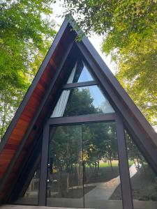 a window in a building with trees in the background at Hotel e Cabanas Perau CABANAS in Ametista do Sul