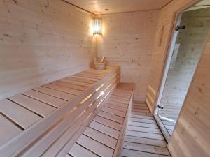 a sauna with a wood paneled wall at Chalupa Zátyní - celý objekt in Dubá +59 photos