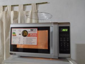 a microwave oven sitting on top of a counter at A&M Alojamiento - Lluvia de Oro 2554 in Puerto Rico