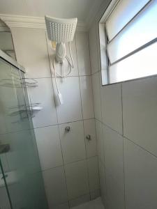a bathroom with a shower with a glass door at 1º Ap decorado do GALO em frente à ARENA MRV in Belo Horizonte
