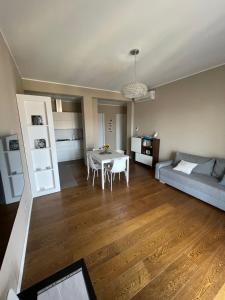 a living room with a couch and a table at Morivione Apartment - Bocconi free parking in Milan