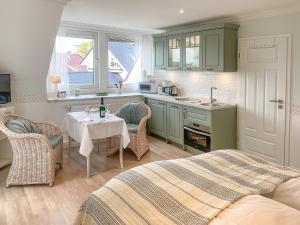 a kitchen with a bed and a table in a room at Haus Midsommer in Timmendorfer Strand