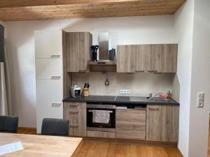 eine Küche mit Holzschränken und einer Arbeitsplatte in der Unterkunft Schwarzenbergerhof in Reith im Alpbachtal