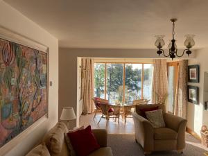 a living room with a couch and a table at Bluebell lake house in Enniskillen