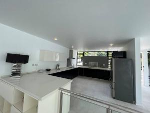 a kitchen with a stainless steel refrigerator in it at Villa moderne à Trou aux Biches in Trou aux Biches