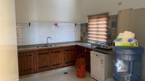 a kitchen with a sink and a counter top at Wadi Al-Nakhil Hostel in Al Khuraybah