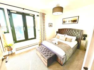 a bedroom with a bed and a large window at The Penthouse Margate, Balconies, Sea View, Gated Parking, Air Con! in Margate